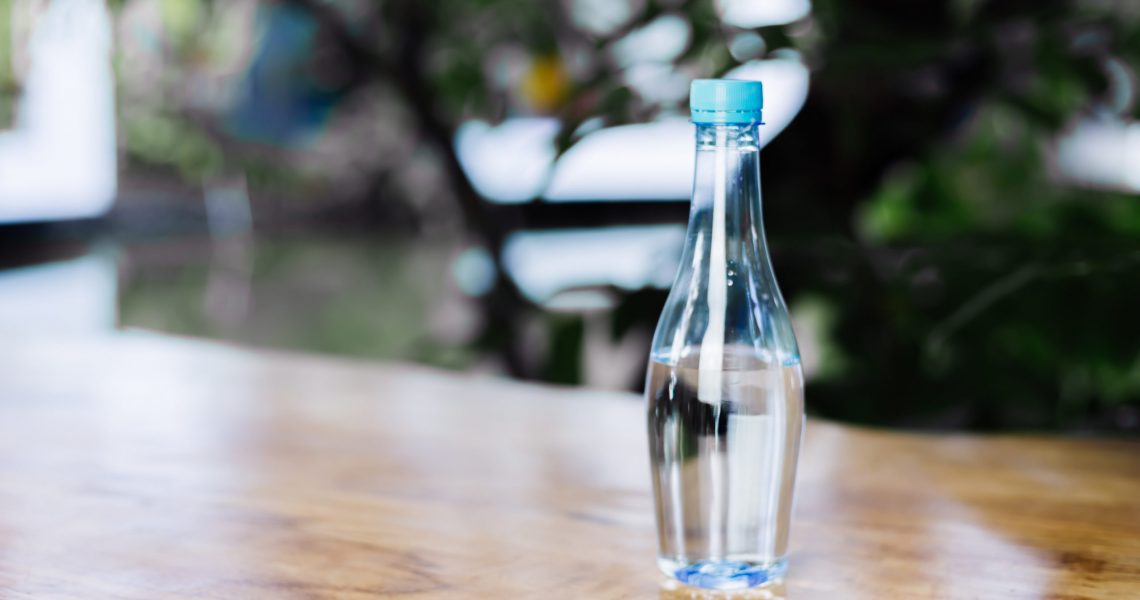 plastic-bottle-of-water-on-wooden-table